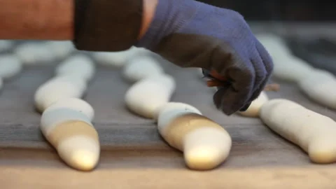 Baker slices bread before baking in a bakery in Istanbul, Turkey Stock Footage 327543672