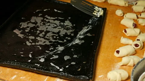 Baker smears and oils the baking oven tray pan Video stock 61197139
