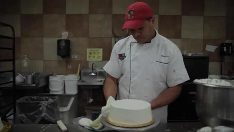 A baker spins a cake on a turner Stock Footage 231414521