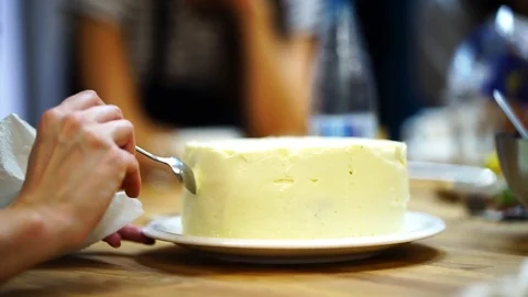 A baker spreads cream on top cake. make the cake Video stock 72256733