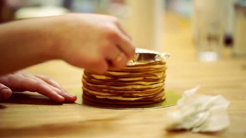 A baker spreads cream on top cake. make the cake Video stock 72256748