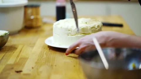 A baker spreads cream on top cake. make the cake Video stock 72256752