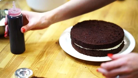 A baker spreads cream on top cake. make the cake Video stock 72256765