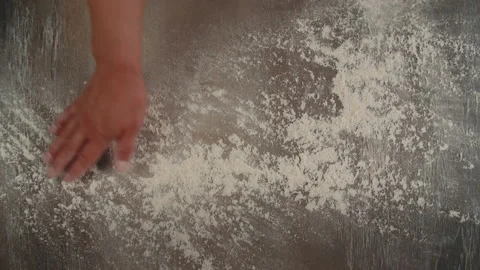 The baker spreads the flour evenly on the board before starting to cook Video stock 201547028