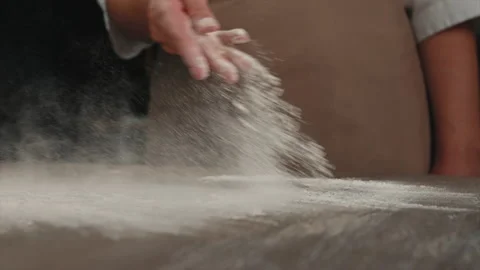 The baker sprinkles the board with flour. Slow motion Stock Footage 201546887