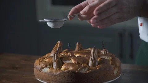 Baker sprinkles prepared pear cake. Pie and bakery. Bake food on cuisine. Stock-Footage 124756792