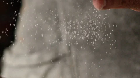 Baker sprinkling powdered sugar onto a cake with a sieve Stock Footage 274689191