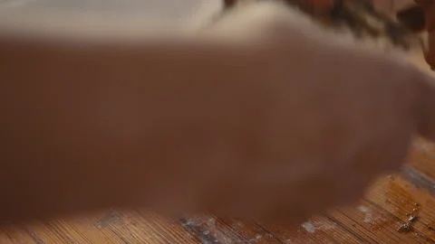 Baker stacking seasoned bread-dough strips Stock Footage 274681079