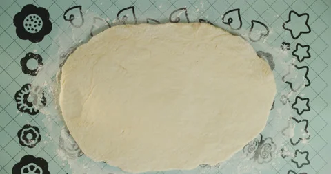Baker starts to roll out the dough Stock Footage 130573889