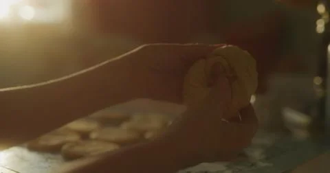 Baker starts to shape dough using hands Photos