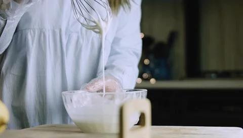 Baker Stirring a Thick Cookie Mixture at the Kitchen Table Stock Photos