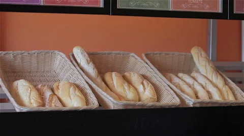 Baker take (and put) a loaf on shelf with tongs Video stock 55500638