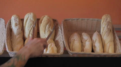 Baker take (and put) a loaf on shelf Stock Footage 55501458