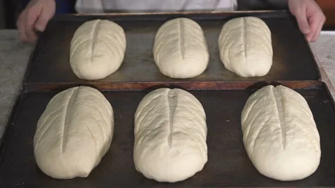 The baker takes a batter with dough. slow motion Видео 100739574