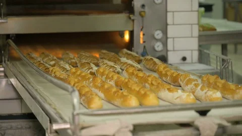 The baker takes bread out of the oven. Ready-made bakery products. Stock Footage 82716877