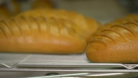 The baker takes bread out of the oven. Ready-made bakery products. Stock Footage 82717926