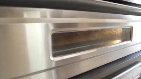 Baker takes the freshly baked bread out of the oven Stock Footage 133088859