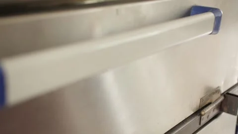 Baker takes the freshly baked bread out of the oven Stock Footage 133088869