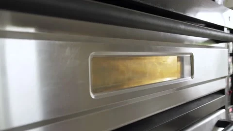 Baker takes the freshly baked bread out of the oven Video stock 133088908