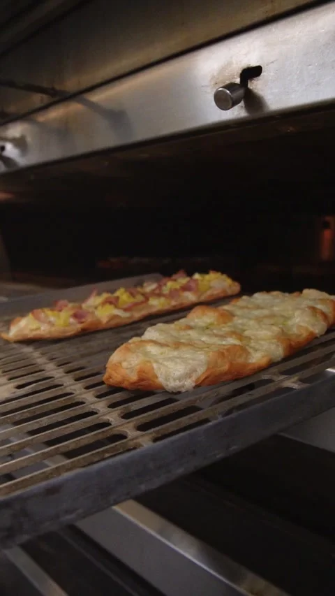 Baker takes freshly baked bread out of the oven. Stock Footage 306006705