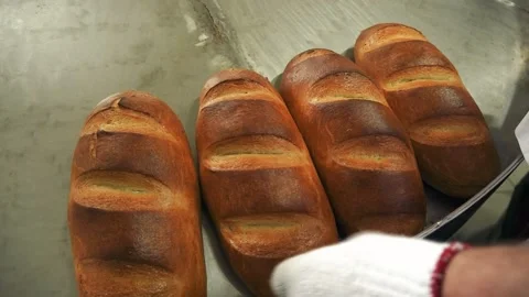The baker takes hot bread with his hands Stock Footage 143076725