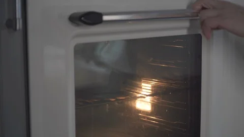 Baker takes out a pear cake in a baking dish from the oven. Pie and bakery. Stock Footage 124754046