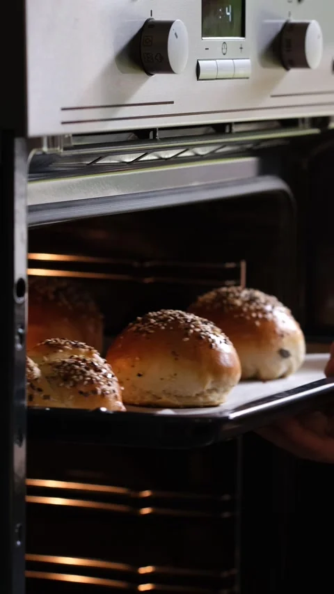 Baker taking buns from oven. High quality FullHD footage Stock-Footage 162918261
