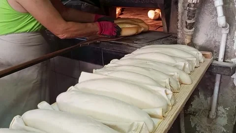 Baker Taking Fresh Bread Out of Traditional Stone Wood Fired Oven Stock Footage 332120225