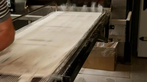 Baker taking out fresh French baguettes in the kitchen of the baker house Stock Footage 64471112
