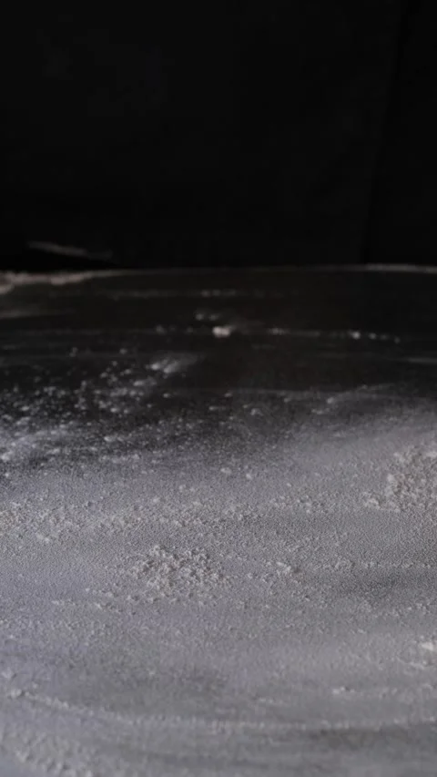 Baker throughts wheat flour with hand. Wheat flour flies dust over the table Stock-Footage 163302706