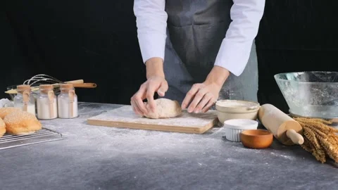 Baker throws yeast dough on a wooden tray for kneading the dough. Stock Footage 147088853