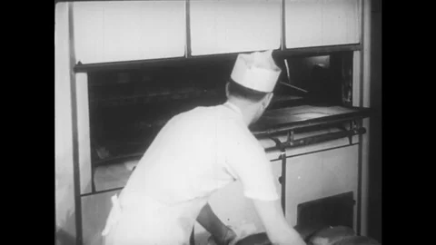 A baker trains an apprentice in the process of baking bread. Video stock 74568394