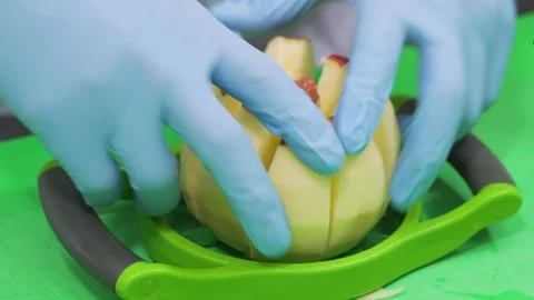 Baker Using Green Slicer Tool to Core and Slice Fresh Apple for Homemade Pie Pre Stock Footage 337751316