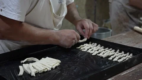 Baker using the metal tray Stockbeeldmateriaal 345375439