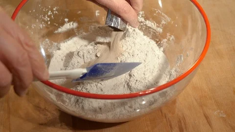 Baker at work: Add yeast to bread dough Stock Footage 86864329