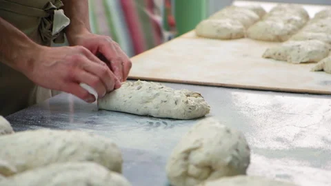 Baker at work. The baker shapes the bread Stock Footage 196243083
