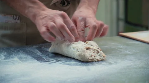 Baker at work. The baker shapes the bread Stock Footage 196243084