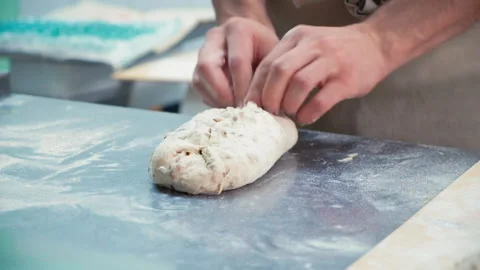 Baker at work. The baker shapes the bread Stock Footage 196243441
