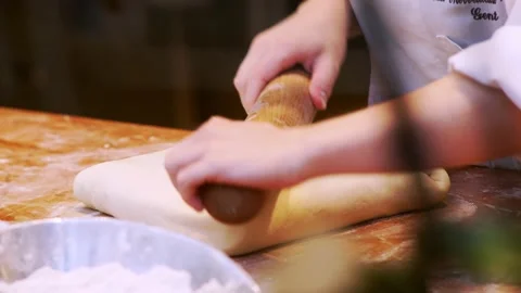 Baker work with raw dough piece on wooden table Video stock 145790124