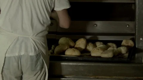 Baker at work while preparing the bread Stock Footage 76074453
