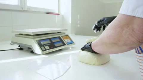Baker working with dough to prepare buns and bread Stock Footage 280584159