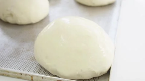Baker working with dough to prepare buns and bread Stock Footage 280584606