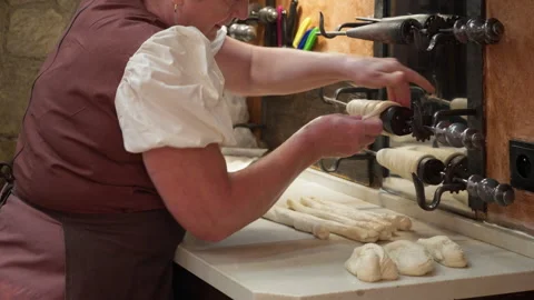Baker Wraps Raw Dough Onto Metal Spit To Prepare Traditional Trdelnik Pastry Stock Footage 342279867
