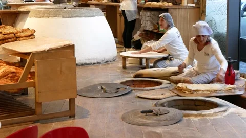 Bakers baking flat white bread in earthenware oven. Process of tandoor cooking Stock Footage 237741864