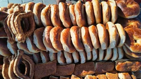 Bakers display different types of bread and pastries at a market Stock Photos
