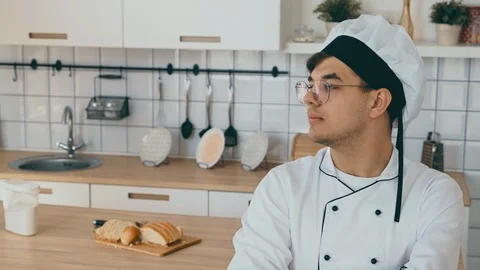 The baker’s face is looking at the camera. Men's work. People job cuisine 4k. Stock Footage 114541864