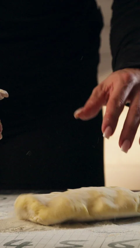 Bakers Hand Dusting Flour And Kneading Dough For Cinnamon Rolls. - vertical shot Video stock 329597124