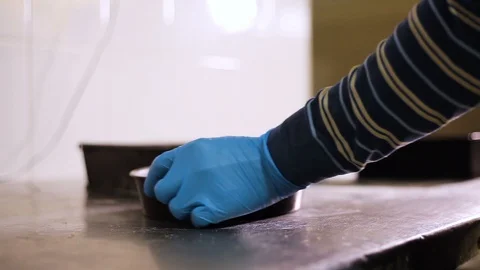 Baker's hand, round baking mold and knife Stock Footage 106459201