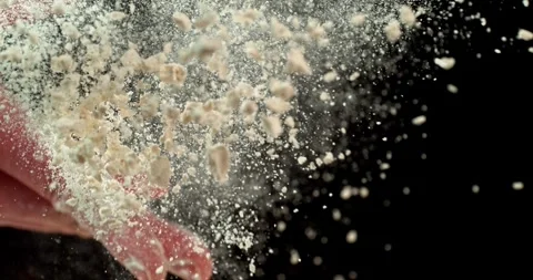 Baker’s hand tossing flour over prepared risen dough on wooden table Stock Footage 328711133