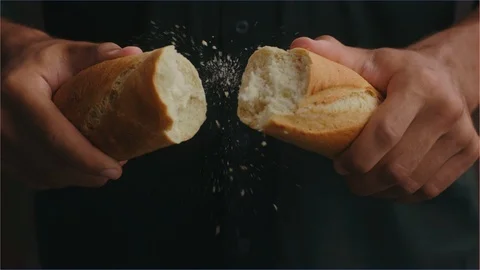 Baker's hands breaking a bread roll in slow motion Stock Footage 107129698